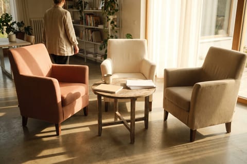 Three different empty chairs around a small round table